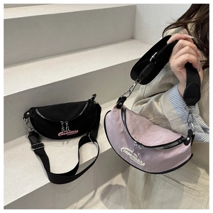 Detail of crescent nylon crossbody bags in black and purple with adjustable wide straps