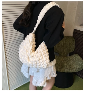 Detail of white puff hobo bag showing high-capacity design and bubble texture fabric