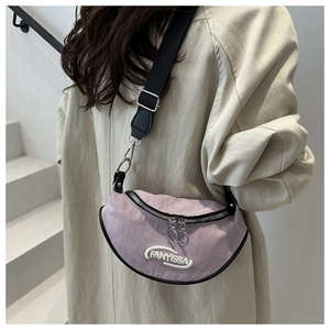 Detail of lavender canvas crossbody bag with FANYISSA embroidery and metal zippers