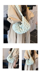 Detail of the mint green pleated texture and ruched shoulder strap on this cloud bag