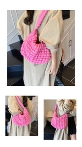Detail shot of bright pink bubble texture fabric on a stylish ruched tote shoulder bag