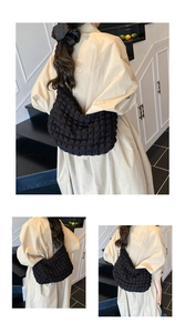 Detail of a black bubble textured crossbody bag showing soft pleated fabric and puffy design