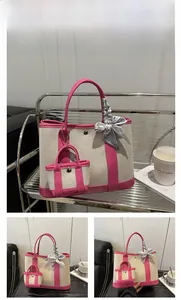 Close-up of rose red canvas tote bag set with decorative silk scarf and mini pouch
