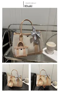 Detail view of khaki canvas tote with silk scarf and matching mini pouch bag set