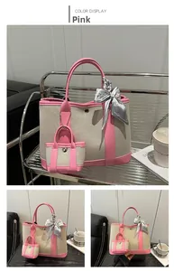 Detailed view of pink canvas tote bag with leather trim and decorative silk scarf