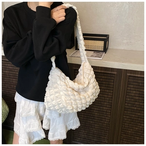 Close-up of white bubble texture tote bag with stylish ruffled shoulder strap design