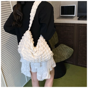 Close-up of white bubble texture fabric and crescent shape of the hobo shoulder bag