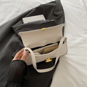 White crocodile pattern baguette bag with gold buckle shown with phone and wallet inside