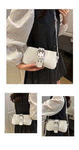 Detailed views of white crocodile pattern shoulder bag with silver buckle and rivets
