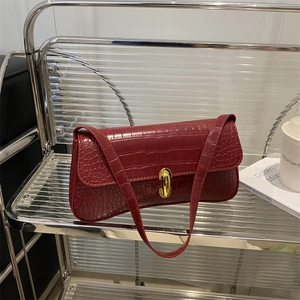 Minimalist burgundy baguette shoulder bag with crocodile texture and gold hardware
