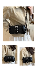 Detail of black crocodile pattern faux leather bag with silver eyelets and metal buckle