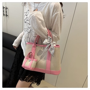 Detail of canvas tote bag with pink leather trim, silk scarf and mini pouch attachment