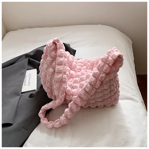 Detail of pink bubble texture pleated shoulder bag showing premium waffle fabric