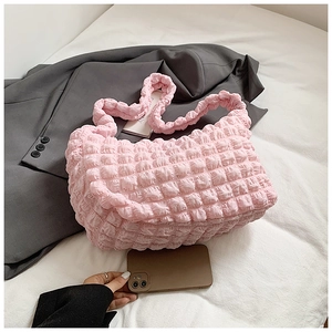 Detailed view of pink bubble pleated fabric texture on a soft puffy cloud shoulder bag