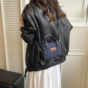 Mini washed denim handbag with white stitching and brown leather patch detail