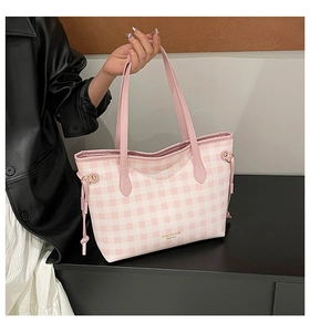 Detail of pink plaid tote bag with golden lettering and decorative side drawstrings