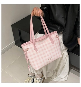 Detail of pink and white checkered tote bag showing leather handles and drawstring sides
