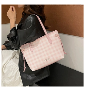 Detail view of pink and white checkered tote bag featuring drawstring sides and thin straps