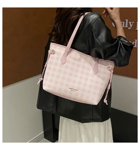 Detail of pink plaid tote bag with SN&FASHION text and drawstring side on a model