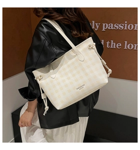 Side view of checkered tote bag with drawstring detail and branded lettering on shoulder
