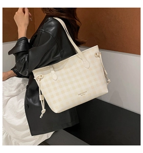 Detail shot of cream plaid tote bag showing its large capacity and drawstrings
