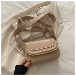 Close-up of beige PU leather crossbody bag with detailed stitching and gold hardware