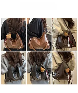 Détail d'un grand sac cabas vintage en marron et gris avec pendentif ours en peluche doux