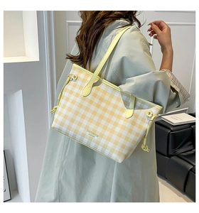 Detail of yellow and white checkered tote bag with drawstring and shoulder strap