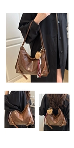 Détail du grand sac cabas vintage en cuir souple avec un petit pendentif ours brun
