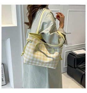 Detail of yellow and white plaid tote bag with side drawstring and SN&FASHION print
