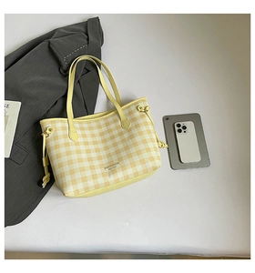 Detail of yellow plaid tote bag with side drawstrings and SN&FASHION logo for daily commute