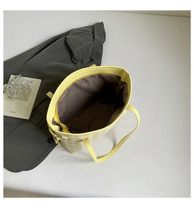 Top view of yellow plaid tote bag showing zipper closure and spacious brown interior