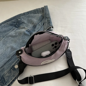 Purple nylon crescent chest bag with adjustable strap and interior phone storage capacity