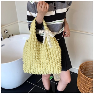 Detail of yellow popcorn fabric tote bag with white lace bow on shoulder strap