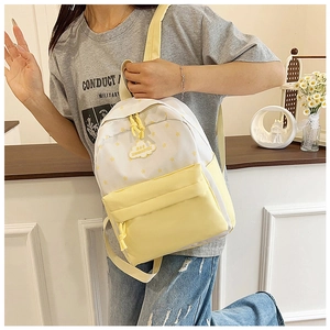 Détail du motif d'étoiles jaunes et de l'écusson nuage sur le sac à dos en nylon blanc