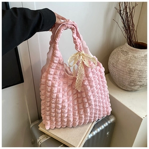 Detailed macro view of pink puffy bubble fabric tote bag with cream lace bow accent