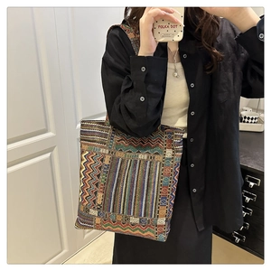 Detailed view of bohemian woven tote bag showing vibrant geometric patterns and texture