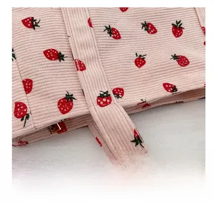 Close-up of the strawberry print corduroy shoulder bag with detailed reinforced stitching