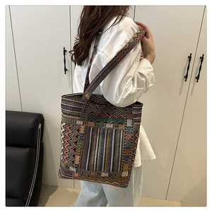 Close-up of bohemian woven tote bag showing colorful geometric jacquard patterns