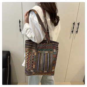 Macro shot of ethnic woven tote bag with colorful geometric patterns and thick texture