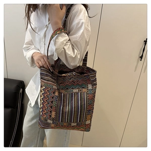 Detailed texture of ethnic woven tote bag with colorful wave patterns and large capacity