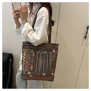 Detailed weave pattern on a bohemian style large tote bag with geometric colorful ethnic motifs