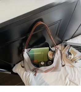 Interior view of large grey canvas tote bag with brown straps showing spacious storage