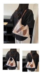 Detail view of large canvas tote bag with brown leather zipper pocket and strap