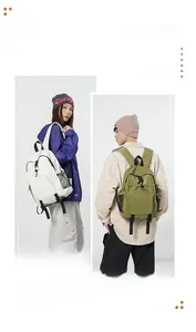 Detailed view of white and olive green waterproof nylon backpacks with side mesh pockets