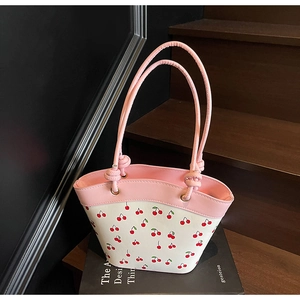 Detail of pink and white cherry print bucket bag showing high-quality metal eyelets