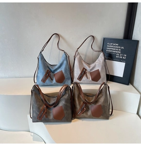 Macro detail of large tote bags in four retro colors on minimalist display stand