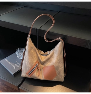 Detail of vintage canvas tote with brown leather accents and functional zipper pocket