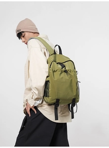 Detailed side view of an olive green backpack with textured ripstop fabric and mesh pocket