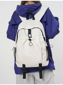 Detail of off-white travel backpack with drawstring pocket and mesh side pouches